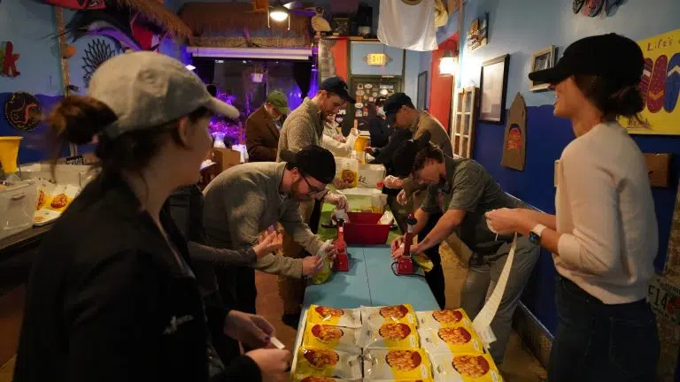 NT Concepts employees packing meals inside of a restaurant