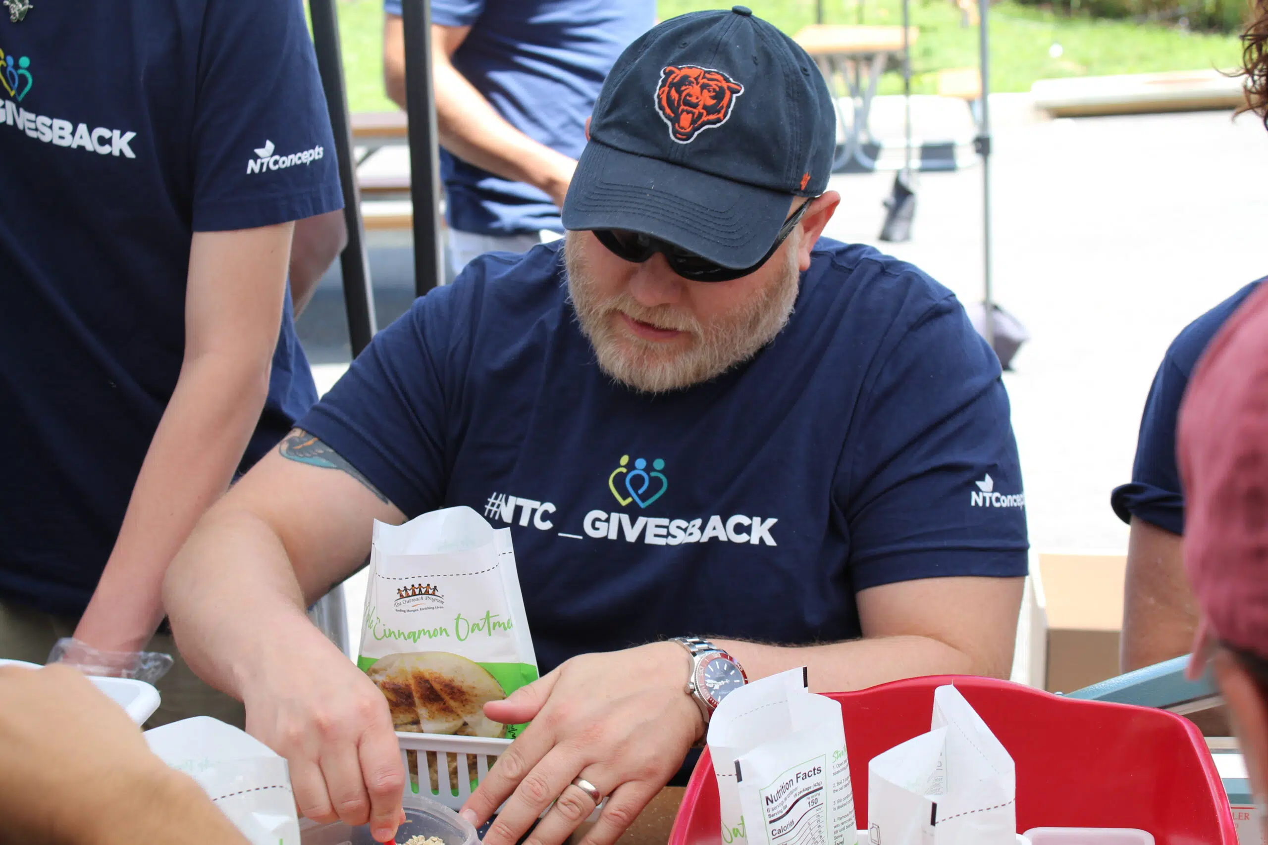 A photo of Chris Gros, VP of Talent, packaging food at one of our Flash Packs