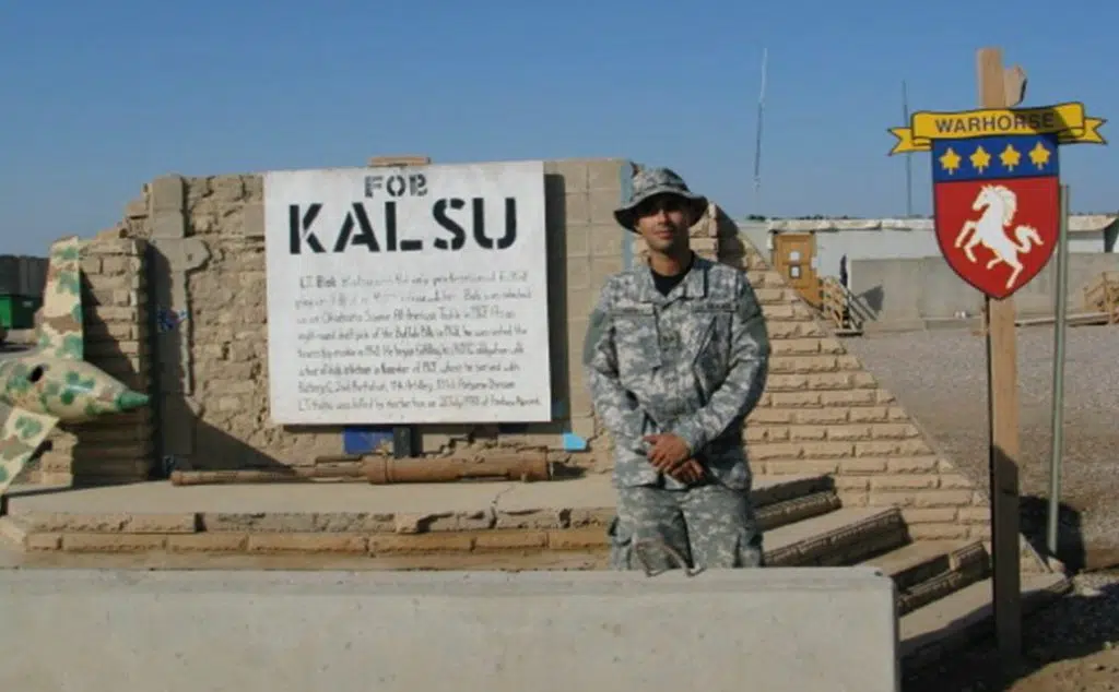 Joel Ybarra standing in fatigues at Forward Operating Base Kalsu